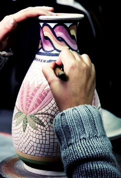 This photo of a woman detailing a mosaic vase embodies the handcrafted spirit that has always been embraced by humankind.  Photographer unknown.  Let us know who you are!